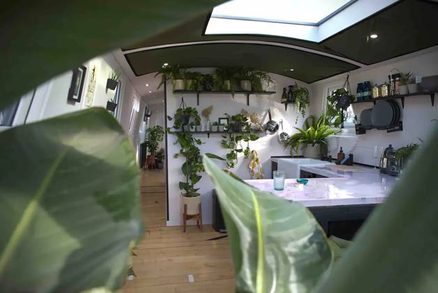 Love plants? Stay in London™s first live-in terrarium boat this summer Story from Jam Press (Terrarium Boat) Pictured: The kitchen. Love plants? Stay in London™s first live-in terrarium boat this summer Are you a plant lover? A water babe? Well, now you can take both to the next level with a stay on a ˜terrarium boat . Moored on a canal in Hackney, London, this life-size ecosystem is made for those who want to get close to nature. The 48.3 sq m boat is decked out with 150 verdant houseplants - making it a perfect live-in oasis. Terrariums are more commonly known to be small, sometimes big, glass enclosures filled with plants, stones and mosses. But this one is a floating, green sanctuary. The two-guest property is comple Copyright: xJamxPress @thefloatingterrarium