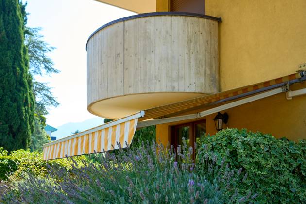 Nago-Torbole, Lake Garda, Italy - 15 July 2024: Awning on a vacation apartment on Lake Garda offers optimum sun protection and increases outdoor living comfort. Awning provides pleasant shade and a cozy ambience on the terrace in Italy