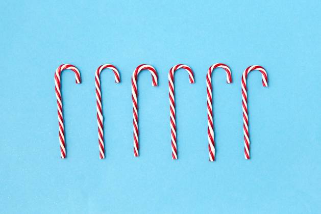 christmas and winter holidays concept - candy cane decorations on blue background. candy cane decorations on blue background ,model released, Symbolfoto