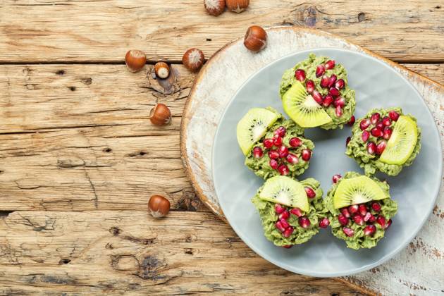 Diet avocado cupcakes garnished with kiwi and pomegranate.Cupcakes on wooden background. Cupcakes from avocado and kiwi. ,model released, Symbolfoto