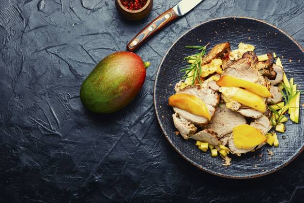 Delicious grilled meat with mango and cheese.. Fried pork with mango and cheese. ,model released, Symbolfoto