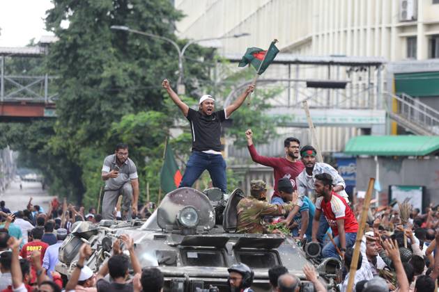 August 5, 2024, Dhaka, Wari, Bangladesh: Anti-government protestors celebrate in Shahbag near Dhaka university area in Dhaka on August 5, 2024. Protests in Bangladesh that began as student-led demonstrations against government hiring rules in July culminated on August 5, in the prime minister fleeing and the military announcing it would form an interim government.People gather to celebrate the fall of Bangladesh Prime Minister Sheikh Hasina after an intense clash between police, pro-government forces, and anti-Quota protesters in Dhaka, Bangladesh. Dhaka Bangladesh - ZUMAr336 20240805_zip_r336_059 Copyright: xHabiburxRahmanx