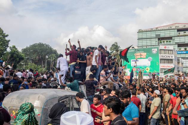 August 5, 2024, Dhaka, Bangladesh: Anti-government protestors march on the street during the celebrations. Thousands of people are celebrating the resignation of Bangladeshi Prime Minister Sheikh Hasina..Protests in Bangladesh that began as student-led demonstrations against government hiring rules in July culminated on August 5, in the prime minister fleeing and the military announcing it would form an interim government. Dhaka Bangladesh - ZUMAs197 20240805_aaa_s197_082 Copyright: xSazzadxHossainx