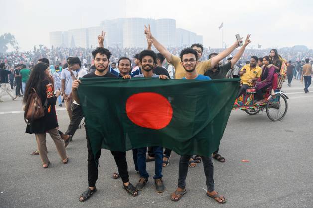 August 5, 2024, Dhaka, Bangladesh: Anti-government protestors gather at the parliament house during the celebrations. Thousands of People celebrate the resignation of Bangladeshi Prime Minister Sheikh Hasina. Protests in Bangladesh that began as student-led demonstrations against government hiring rules in July culminated on August 5, in the Prime Minister fleeing and the military announcing it would form an interim government. Dhaka Bangladesh - ZUMAs197 20240805_aaa_s197_105 Copyright: xPiyasxBiswasx