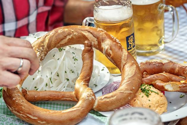 Beer and snack in a Munich beer garden, summer day, Munich, August 2024 Germany, Munich, August 2024, two half beers and a hearty snack in a Bavarian beer garden, Augustiner beer, Obazda with pretzel, plate with radish, typical Bavarian, summer, summer day, drink, enjoy, joie de vivre, Bavaria, Bavarian,