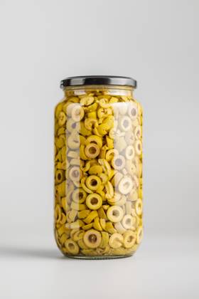 Sliced pickled green olives in brine in jar on gray background. Sliced pickled green olives in brine in jar on a gray background. Copyright: xZoonar.com JirixHERAx 22015852