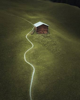 A cozy wooden cabin secluded in the Swiss Alps, accessible by a winding path through a lush green meadow. Model Released Ca_maraphy_ID23343_678643_005 Copyright: xCAxMARAPHYx RECORD DATE NOT STATED