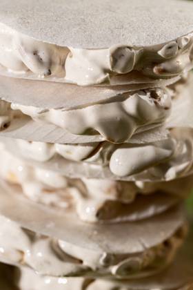 A detailed close-up view of layered traditional Christmas sweets, featuring slices of white nougat Turron de Alicante. Model Released AlexSalcedo_ID24574_712225_011 Copyright: xAlexxSalcedox RECORD DATE NOT STATED