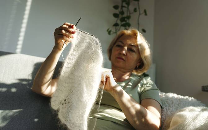 Senior woman holding woolen woven fabric at home model released, Symbolfoto property released, NSTF00357