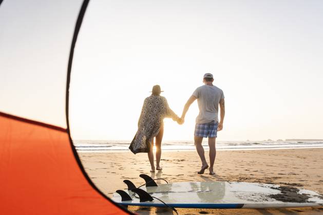 Romantic couple camping on the beach, doing a beach stroll at sunset model released, Symbolfoto, UUF15147