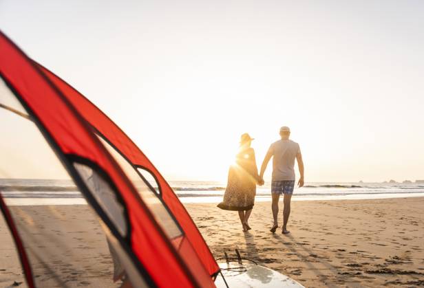 Romantic couple camping on the beach, doing a beach stroll at sunset model released, Symbolfoto, UUF15152