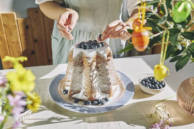 Woman decorating Pandoro bread with blueberries model released, Symbolfoto property released, CATF00575