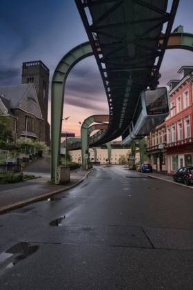 Low angle shot of a suspension railroad over Wuppertal s street in Germany , 50852272.jpg, low angle, building, construction, exterior, architecture, suspension, railroad, path, way, wuppertal, germany, europe, sunset, dusk, evening, beautiful, transportation, schwebebahn, transport, railway, public, elberfeld, train, sky, wuppertaler schwebebahn, historical, north rhine-westphalia, bridge, steel, travel, tram, traffic, monorail, floating tram, wupper, public vehicle, dsseldorf, wuppertaler, wupper valley, suspension railway, rail transport, ironwork, barmen, vehicle RECORD DATE NOT STATED