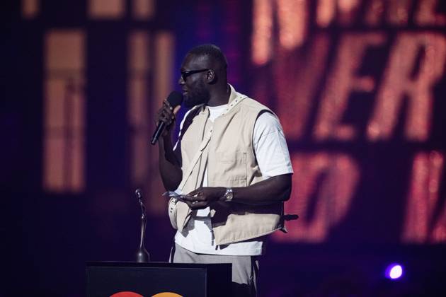 Stormzy being presented the BRIT Award for Hip Hop Grime Rap Act at the 2025 BRIT Awards at The O2 Arena, London on 1 March 2025 Stormzy being presented the BRIT Award for Hip Hop Grime Rap Act at the 2025 BRIT Awards at The O2 Arena, London on 1 March 2025 Stormzy (Michael Ebenezer Kwadjo Omari Owuo Jr.) is an English-Ghanaian rapper, singer, and songwriter. In ˜14, he gained attention on the UK underground music scene through his Wicked Skengman series of freestyles over classic grime beats. Stormzy s song Shut Up , which was initially released as a freestyle on YouTube, became popular and peaked at number eight on the UK Singles Chart., Credit:Dafydd Owen Avalon The O2, Greater London, London Copyright: xDafyddxOwenx xAvalonx 0970764226