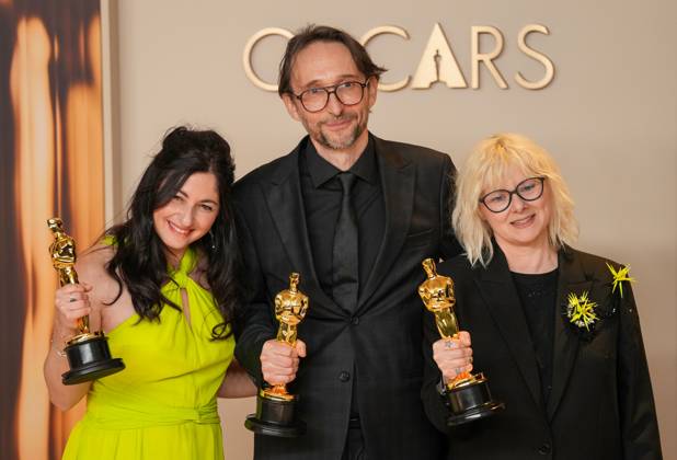 Marilyne Scarselli, Pierre-Olivier Persin, and Stéphanie Guillon (L-R) celebrate backstage after winning the Oscar for makeup and hairstyling for The Substance during the 97th Academy Awards in the Hollywood section of Los Angeles on Sunday, March 2, 2025.  LAP20250302119 PATxBENIC