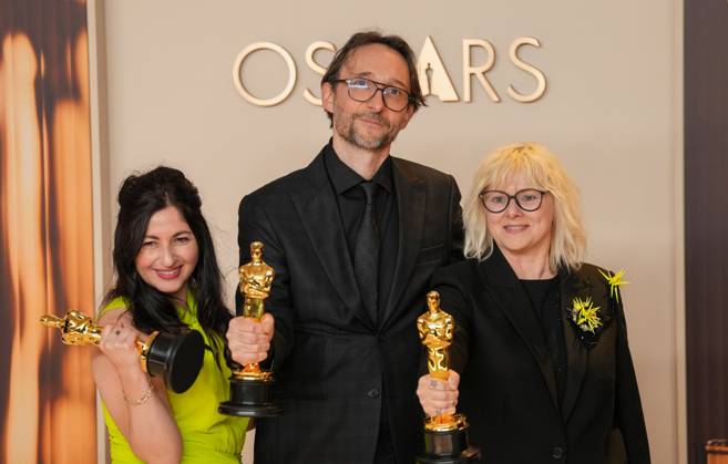 Marilyne Scarselli, Pierre-Olivier Persin, and Stéphanie Guillon (L-R) celebrate backstage after winning the Oscar for makeup and hairstyling for The Substance during the 97th Academy Awards in the Hollywood section of Los Angeles on Sunday, March 2, 2025.  LAP20250302120 PATxBENIC