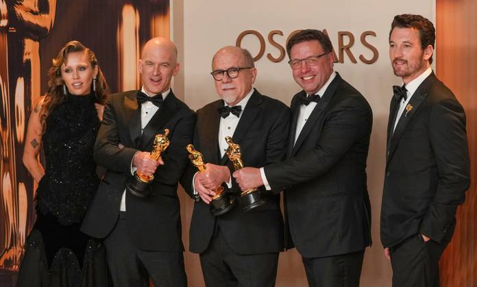 Academy Award presenter Miley Cyrus joins Gareth John, Richard King, Ron Bartlett, and Doug Hemphill (L-R) of Dune: Part Two celebrate backstage after winning the Oscar for best sound during the 97th Academy Awards in the Hollywood section of Los Angeles on Sunday, March 2, 2025.  LAP20250302134 PATxBENIC