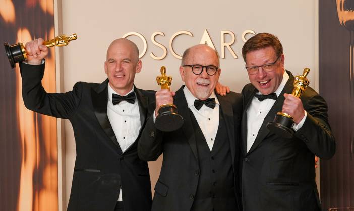 Gareth John, Richard King, and Ron Bartlett of Dune: Part Two celebrate backstage after winning the Oscar for best sound during the 97th Academy Awards in the Hollywood section of Los Angeles on Sunday, March 2, 2025.  LAP20250302136 PATxBENIC
