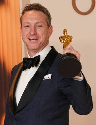 Lol Crawley of The Brutalist celebrates backstage after winning the Oscar for cinematography during the 97th Academy Awards in the Hollywood section of Los Angeles on Sunday, March 2, 2025.  LAP20250302146 PATxBENIC