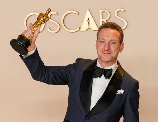 Lol Crawley of The Brutalist celebrates backstage after winning the Oscar for cinematography during the 97th Academy Awards in the Hollywood section of Los Angeles on Sunday, March 2, 2025.  LAP20250302148 PATxBENIC