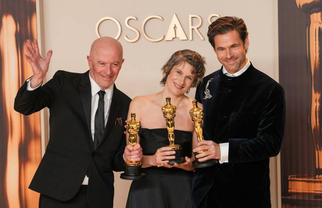 Clément Ducal, Camille, and Jacques Audiard of Emilia Pérez celebrate backstage after winning the Oscar for the original song titled El Mal during the 97th Academy Awards in the Hollywood section of Los Angeles on Sunday, March 2, 2025.  LAP20250302153 PATxBENIC