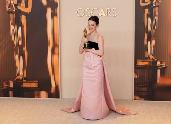 Best performance by an actress in a leading role winner Mikey Madison of Anora celebrates backstage during the 97th Academy Awards in the Hollywood section of Los Angeles on Sunday, March 2, 2025.  LAP20250302176 PATxBENIC