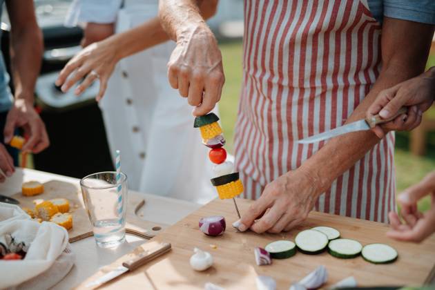 Close up of family preparing food for a spring weekend barbecue. Close up of family preparing food for a spring weekend barbecue. Garden party. model released