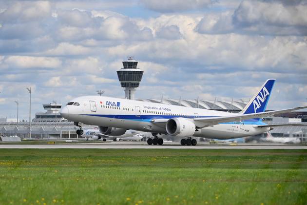 ANA All Nippon Airways JA89IA B787 Dreamliner takes off, takeoff in front of tower and terminal passenger jets at Franz Josef Strauss Airport in Munich Munich