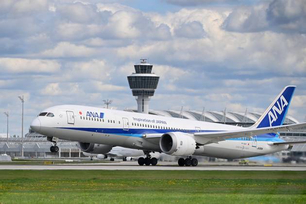 ANA All Nippon Airways JA89IA B787 Dreamliner takes off, takeoff in front of tower and terminal passenger jets at Franz Josef Strauss Airport in Munich Munich