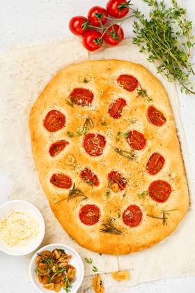 Hausgemachtes traditionelles italienisches Brot mit Kirschtomaten, Parmesan und Rosmarin auf rustikalem hellen Tischhintergrund. Ansicht von oben Hausgemachtes traditionelles italienisches Brot mit Kirschtomaten, Parmesan und Rosmarin auf rustikalem hellen Tischhintergrund. Ansicht von oben (License=RF) Copyright: xZoonar.com KatsiarynaxHuravax 23384268