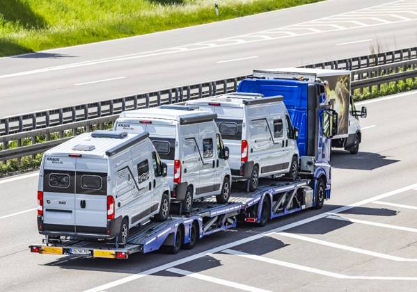 Car transporter with new motorhome on the A8 highway at the Stuttgart Airport junction 12 05 2025 Stuttgart, Baden Württemberg, Germany