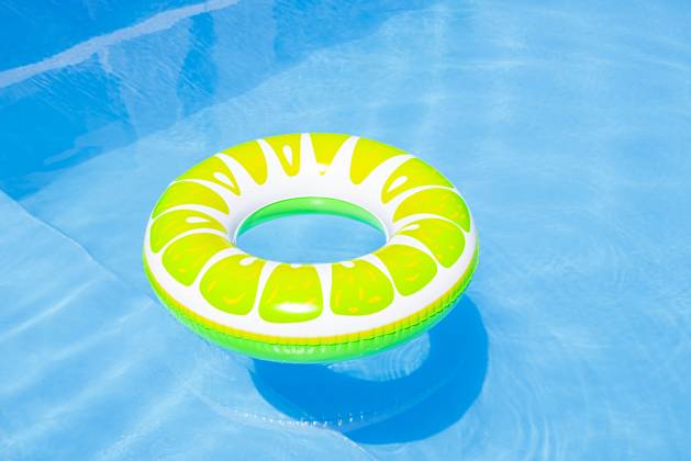 Colorful inflatable pool float in a sunny swimming pool property released, FLMF01412