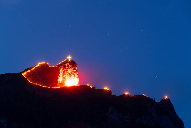 Solstice bonfires at Lake Achensee Mountain bonfires at the summer solstice can be seen on the peaks of the Alps at Lake Achensee , Maurach Tirol Austria
