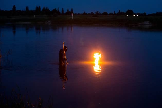 June 21, 2025, Cigacice, Lubusz Voivodeship, Poland: A man in black robe is standing in the Odra River during the Kupala Night celebrations. Kupala Night (Polish: Noc KupaÂ³y) is an old Slavic holiday celebrated on the night of the summer solstice. It combines the cult of nature, fertility, fire and water. Cigacice Poland - ZUMAs197 20250621_aaa_s197_469 Copyright: xKarolxSerewisx