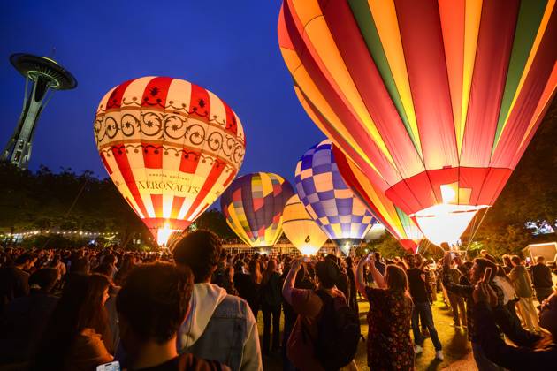 June 22, 2025, Seattle, Washington, USA: A large crowd gathers at the Space Needle to watch a first-time ballooning event. Six one-hundred-foot hot air balloons light up the evening sky. The Glow joins SeattleÃ¢â‚¬â ¢s summer-long celebrations, each embracing the neighborhoodÃ¢â‚¬â ¢s unique flavor. Seattle USA - ZUMAsr6_ 20250622_znp_sr6_002 Copyright: xShanexSrogix