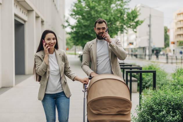 Mother and father with child in stroller talking on mobile phones while walking in the city model released, Symbolfoto, VSNF03424