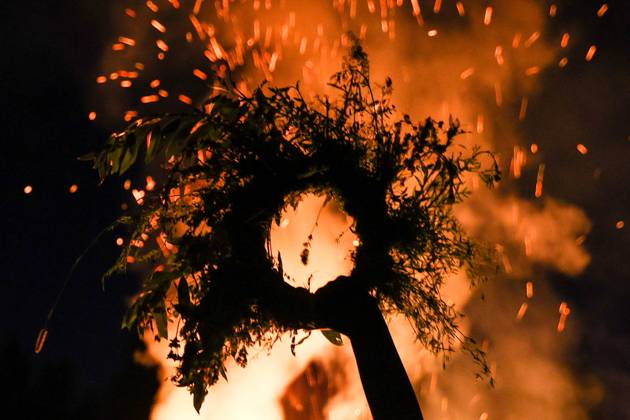 RUSSIA, MOSCOW REGION - JULY 5, 2025: A flower crown is seen in front of a bonfire during festivities marking Ivan Kupala Day, a pagan summer solstice celebration, at the Vasilkovoye Ozero holiday park. Valeria Kalugina TASS  82256444