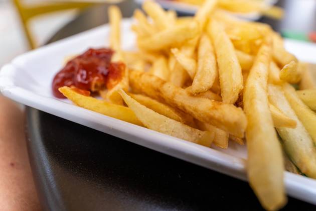 Malcesine, Lake Garda, Italy 20 July 2025: Crispy deep-fried chips with a dollop of ketchup - a popular classic snack that never goes out of fashion as a quick meal or side dish.