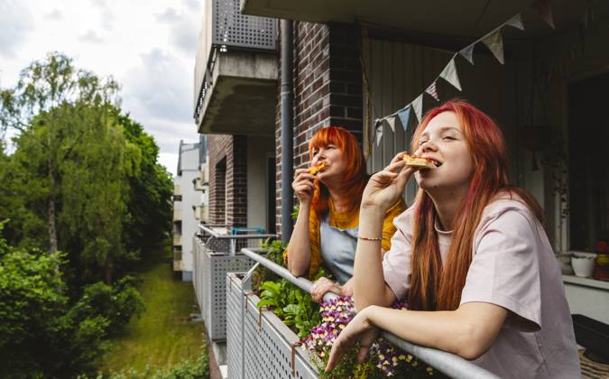 Family enjoying pizza and celebrating together on a balcony model released, Symbolfoto property released, IHF02244