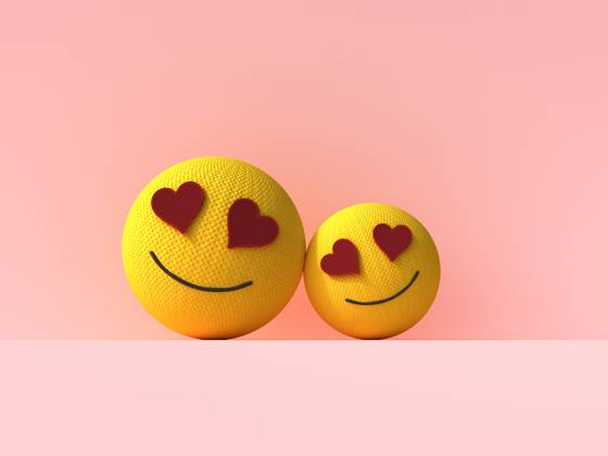 Two heart eyes emoji balls showing love and care on pink background, UWF01921
