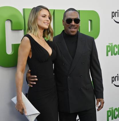 Cast member Eddie Murphy and his wife Paige Butcher attend the premiere of the motion picture comedy The Pickup at Regal LA Live in Los Angeles on Sunday, July 27, 2025. Storyline: A routine cash pickup turns into a deadly pursuit when two mismatched armored truck drivers are ambushed by ruthless criminals with plans beyond the cash.  LAP2025072749 JIMxRUYMEN