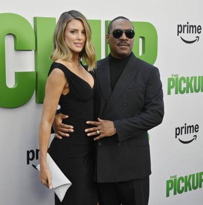 Cast member Eddie Murphy and his wife Paige Butcher attend the premiere of the motion picture comedy The Pickup at Regal LA Live in Los Angeles on Sunday, July 27, 2025. Storyline: A routine cash pickup turns into a deadly pursuit when two mismatched armored truck drivers are ambushed by ruthless criminals with plans beyond the cash.  LAP2025072702 JIMxRUYMEN