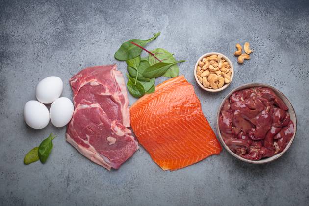 Food ingredients high in iron for health and wellness top view on grey concrete background Fresh salmon fillet, raw beef, nutritious eggs, spinach, nuts cashews and liver arranged on a gray background, iron rich foods essential for a balanced diet concept, 63688216.jpg RECORD DATE NOT STATED