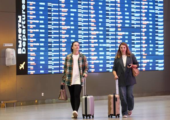RUSSIA, MOSCOW REGION - SEPTEMBER 17, 2025: Women wheel along their suitcases at Sheremetyevo International Airport. Sofya Sandurskaya TASS  84063943