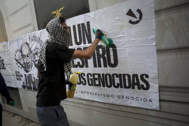 October 4, 2025, Madrid, Madrid, Spain: A protester, his face covered by a keffiyeh, pastes a mural.against genocide, during a pro-Palestinian demonstration in central Madrid in solidarity with the Palestinian people in the face of Israeli attacks and condemning the interception by Israeli forces of the Global Sumud Flotilla ships. Madrid Spain - ZUMAs296 20251004_znp_s296_007 Copyright: xLuisxSotox