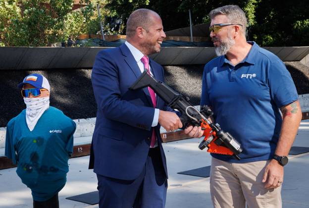 Minister of Defence and Foreign Trade Theo Francken pictured with a Semi-Automatic less-lethal gun FN 303 during a FN Demo at LAPD Los Angeles Police Department, in Los Angeles, part of an economic mission to the west coast of the United States, on Thursday 09 October 2025. The Belgian Economic mission to USA takes place from October 4th to 12th. BENOITxDOPPAGNE 136440281