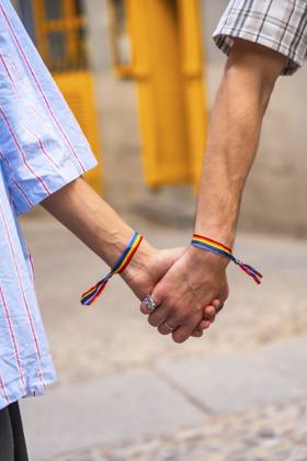 Die Hände des Paares halten sich zusammen, beide Handgelenke mit Regenbogenarmbändern, die Liebe, Stolz und Unterstützung für die lgbtq plus Gemeinschaft symbolisieren und für Gleichheit stehen Couple s hands holding together, both wrists featuring rainbow bracelets, symbolizing love, pride, and support for the lgbtq plus community, representing equality Copyright: imageBROKER UnaixHuizi ibxuhu15317623.jpg ,model released, Symbolfoto ,property released