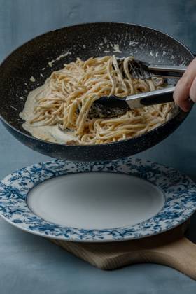 Transfer the spaghetti pasta from the loop to a plate Toru?, Kuyavian-Pomeranian Voivodeship, Poland R_ORVG251031-1870643-01