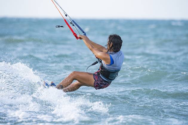 MR_ID31715_22956_LauraGiralgo.jpg A woman enjoys kitesurfing in the vibrant blue waters of Mayapo, La Guajira, Colombia. The wind and waves create the perfect backdrop for an exhilarating water sport experience Model Released VictorCuenca_ID31715_1078690_009 Copyright: xVictorxCuencax