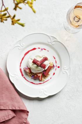 Individual pavlova on a vintage style plate with poached rhubarb, strawberries, lemon creme fraiche and crumble Individual pavlova on a vintage style plate with poached rhubarb, strawberries, lemon creme fraiche and crumble Copyright: xCharlottexOrrx CO150825-6